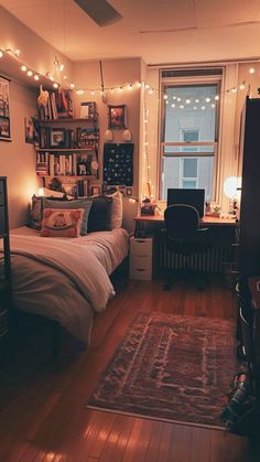 a bed room with a neatly made bed and lots of lights hanging from the ceiling