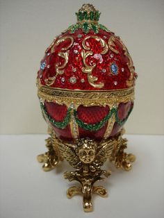 an ornately decorated red and gold egg