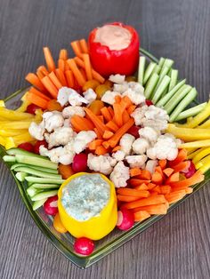 a platter with carrots, cauliflower and other vegetables