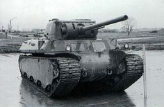 an old tank sitting on top of a wet ground