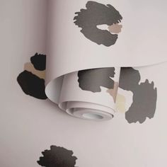 a white wall with some black and brown designs on it