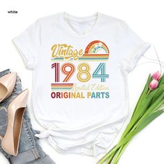 Retro 40th Birthday Tee, Born in 1984, Vintage 1984 Tshirt, 40th Birthday Gift Women, 40 Years Birthday Shirt, 1984 Birthday Limited Edition ----- How To Order ----- 1-) Please, check and review all the photos. 2-) Choose your t-shirt size and color. *Different styles of shirts may have different shades of same color choice due to different manufacturer brands. *For this reason, we recommend you to match shirts from the same styles if you want precisely matching colors (ex. Unisex, V-necks, Todd 1984 Birthday, Birthday Tee, Matching Colors, 40th Birthday Gifts, Kids Graphic Tees, Shirt Fits, Birthday Gifts For Women, Birthday Shirt, 40th Birthday