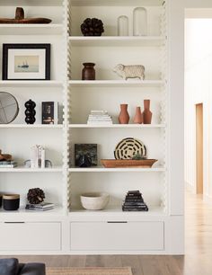 a white bookcase filled with lots of books