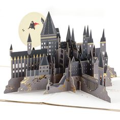 Pop-up greeting card features Harry Potter and the Golden Snitch in flight with a gold foil border and a "Magic & Adventure" message on the front. Simply open the card to reveal the 3D pop-up surprise insideno assembly required: an intricate, laser-cut Hogwarts Castle pops out with Ron, Hermione and other favorite characters at the base while Harry pursues the Golden Snitch highlighted against a die-cut moon. Shimmering gold foil accents add to the fun. This exquisitely detailed card crafted Harry Potter Pop Up, Arte Pop Up, Harry Potter Pop, Harry Potter Hogwarts Castle, Pop Up Greeting Cards, Hogwarts Castle, Harry Potter Birthday, Pop Up Book, Lasercut Design