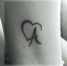 a heart tattoo with the letter a in it's center and an arrow at the bottom