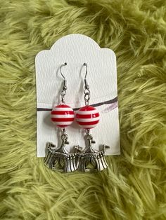 "Who would not want to wear this cute  Circus Tent Earrings. Bring the Circus life to you through this festive earrings which features charms in the shape of a circus tent and accented with a plastic red and white stripe bead.  These earrings are a great way to show the daring side of you.   Dimensions:  Earrings: 2 1/2\" Circus Tent: 20x20mm or 7/8\" Drop Length: 1 6/8 \" Great gift for any special occasions. These beautiful Earrings are ready to ship and will arrive in an organza bag, ready for gifting or safe keeping. Thank you for visiting my shop" Fun Nickel-free Silver Earrings, Fun Silver Earrings For Birthday, Fun Adjustable Earrings For Birthday, Whimsical Hypoallergenic Party Earrings, Whimsical Adjustable Hoop Earrings As Gift, Playful Jewelry With Matching Earrings For Party, Novelty Hypoallergenic Party Earrings, Playful Hoop Earrings For Gift, Novelty Hypoallergenic Earrings For Party