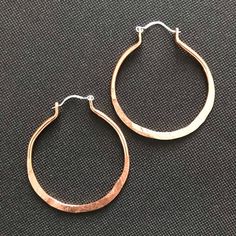 These stunning copper earrings are done in a simple elegant hoop design. The ones in the Pictures measure 2 1/4 inches from the top of the ear wire to the bottom of the earring. And they are 1 3/4 inches wide. (SIZE LARGE)They are also available in a smaller Size of 1 3/4 inches long and 1  1/4 inches Wide (SIZE MEDIUM) or 1.25 long and 1 inch wide( Size SMALL)Please choose Size LARGE,MEDIUM, or SMALL when Ordering. Also Choose Copper or Sterling Earwires.( the earwires in the pictures are sterl Bronze Metal Hoop Earrings, Hammered Copper Hoop Jewelry, Small Copper Hoop Jewelry, Hammered, Silver Hoop Jewelry Made Of Copper, Silver Copper Hoop Jewelry, Silver Hoop Jewelry In Copper, Silver-colored Copper Hoop Jewelry, Everyday Metal Hoop Earrings With Ear Wire, Hand Forged Copper Dangle Hoop Earrings