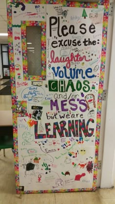 a classroom door with writing on it and words written all over the front, side, and back