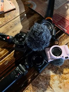 a camera and microphone sitting on top of a wooden table