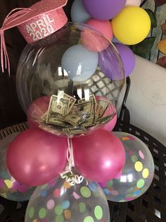 balloons, money and streamers are sitting on a table