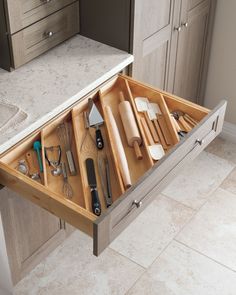 a kitchen drawer with utensils in it