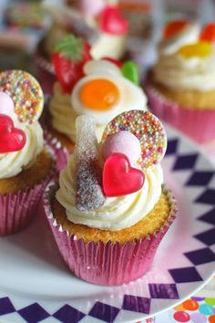 some cupcakes with frosting and hearts on them