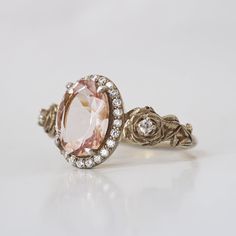 "Captivating Morganite Rose Ring: A Timeless Treasure" Fall in love with our Morganite Rose Ring, adorned with its soft and enchanting peachy pink hue that's sure to capture your heart. This dreamy piece is expertly set in your choice of 14K or 18K gold, enhancing its timeless allure. The sculpted roses that grace this ring elevate its beauty, adding a touch of artistry to an already exquisite design. The low-profile setting ensures that the gem gently rests against your skin, creating a spiritu Delicate Morganite Rings With Rose Cut Diamonds, Pink Gold Rose Cut Diamond Wedding Jewelry, Pink Gold Jewelry With Rose Cut Diamonds For Weddings, Exquisite Morganite Rose Gold Rings, Exquisite Rose Gold Morganite Ring, Luxury Pink Halo Ring For Wedding, Elegant Pink Gold Morganite Rings, Elegant Blush Rings For Promise, Elegant Blush Promise Ring