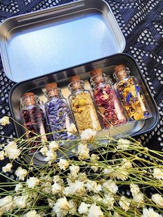 an open tin can filled with flowers and herbs