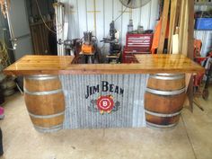 a bar made out of wooden barrels in a garage