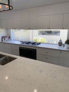 a kitchen with an oven, sink and counter top in it's center island