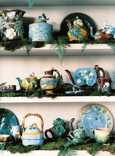 a shelf filled with lots of different types of vases and dishes on top of each other