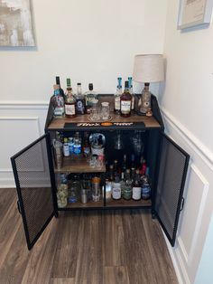 a cabinet with liquor bottles and glasses on it