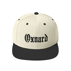 "Oxnard City Cap Snapback Hat This hat is structured with a classic fit, flat brim, and full buckram. The adjustable snap closure makes it a comfortable, one-size-fits-most hat.  * 80% acrylic, 20% wool (green camo is 60% cotton, 40% polyester) * Structured, 6-panel, high-profile * Plastic snap closure * Green under visor * Head circumference: 21 ⅝\" - 23 ⅝\" (54.9 cm to 60 cm)" Classic Flat Cap Fitted Hat For Streetwear, Classic Adjustable Fitted Hat With Flat Crown, Classic Cap For Streetwear, Classic Snapback Baseball Cap, Classic Snapback Hat With Curved Brim, Classic Streetwear Hat With Flat Crown, Classic Baseball Cap For Streetwear, Classic Flat Crown Hat For Streetwear, Classic Snapback Hat For Streetwear