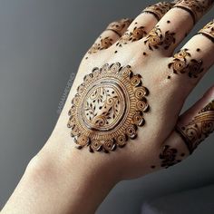 a woman's hand is decorated with hennap and intricate designs on it