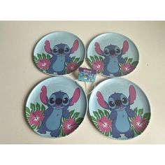 four small plates with cartoon characters on them