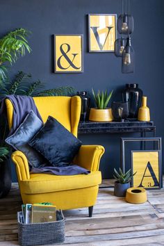 a living room with blue walls and yellow chairs in the corner, black accents on the wall