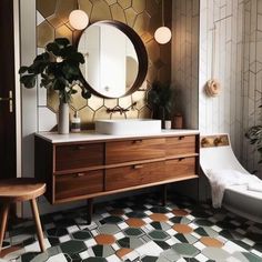 a bathroom with a sink, mirror and bathtub next to a plant on the floor