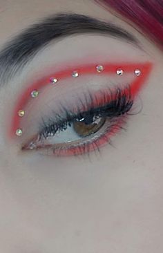 Red Eyeliner With Gems, Red Cheer Makeup, Red Sparkle Eyeshadow, Red Eye Makeup With Rhinestones, Eye Festival Makeup, Red Eyeshadow With Rhinestones, Red And Silver Makeup Looks For Prom, Red Makeup With Rhinestones