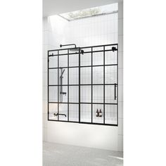 a white tiled bathroom with an open window and black metal frame shower head, hand held faucet