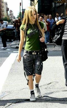 a woman walking down the street in shorts