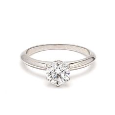 a white gold ring with a single diamond