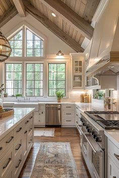 a large kitchen with white cabinets and wooden ceilinging, along with an area rug on the floor