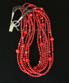 This vivacious Necklace displays a cascade of Bamboo Coral Rounds in appealing coral-red hues. The stones are 5mm in dimension, beautifully shaped, and polished to a glossy sheen. The Coral Rounds are paired with 10-by-13mm Coral Nuggets, adding visual interest to the design. Each Nugget is unique in shape, with subtly faceted and rounded edges. The combination is both classy and timeless — a great way to get your Western on! We've highlighted the Bamboo Coral with 4mm translucent gray Swarovski Multi-strand Red Coral Necklace With Polished Beads, Elegant Adjustable Red Coral Beaded Necklaces, Elegant Adjustable Red Coral Beaded Necklace, Elegant Red Hand-strung Jewelry, Multi-strand Red Coral Beaded Necklaces With Polished Beads, Elegant Multi-strand Red Coral Jewelry, Elegant Red Gemstone Beads, Multi-strand Red Coral Beaded Necklaces, Coral Multi-strand Beaded Necklaces