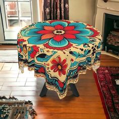 a colorfully decorated table sits in the middle of a living room with a fireplace