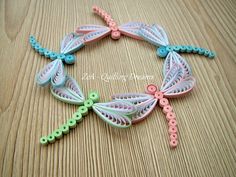 a close up of a bracelet made out of plastic beads and string with dragonflies on it