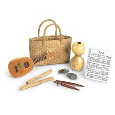 an assortment of musical instruments including a ukulele, music sheets and a basket