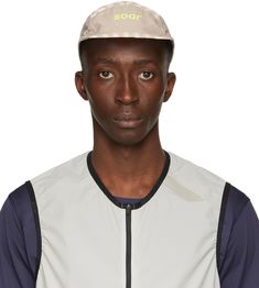 Lightweight paneled mesh cap in taupe. Check pattern in off-white throughout. Quick-drying. Laser-cut perforated detailing at sides. Bonded logo in yellow at face. Flat brim. Textile logo flag in black and bungee-style drawstring with cord-lock fastening at back face. Black hardware. Approx. 2.5 brim length. Supplier color: Grey/White/Sand diamond print Running Cap, Running Clothing, Textile Logo, Mesh Cap, Diamond Print, Jacquard Pattern, Running Clothes, Black Hardware, White Sand