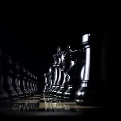 a black and white photo of chess pieces