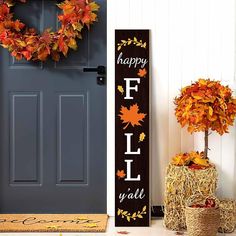 a door with a happy fall y'all sign next to a wreath and hay bales