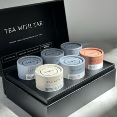 six teas in a black box sitting on a white surface with the words tea with tae printed on it