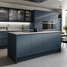 a modern kitchen with blue cabinets and white tile flooring is pictured in this image