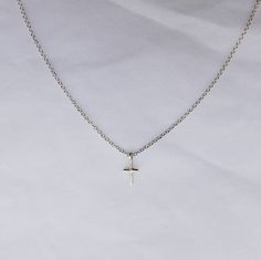 One of our best sellers! A nice basic to add to your neckline - perfect for everyday wear. Super lightweight, this necklace will take permanent residency on your neck. We love the simplicity, meaning, and daintiness of this piece. The cross is a wonderful reminder of hope and faith. Details: Sterling silver handmade cross measures 6/16 of an inch from the top of the bail to the bottom Silver chain 16 inches or 18 inches Free Shipping on Domestic Orders Materials: sterling silver Permanent Residency, Mini Cross, Retail Therapy, The Cross, Handmade Silver, Best Sellers, Silver Chain, Cross Necklace, Arrow Necklace