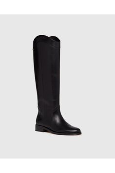 Find PAIGE Raina Boot on Editorialist. Raina is our take on the classic riding boot. Crafted from a super durable yet luxuriously soft black leather, this timeless straight shaft tall boot is designed with a curved topline that dips at the front and back for a flattering look, western-inspired pattern and stitch detailing, an extended leather welt with tonal stitch details, and a black leather stacked 20mm heel for a slight amount of lift. The classic menswear-inspired details on the outsole inc Classic Calf Leather Knee-high Boots With Leather Sole, Classic Knee-high Boots With Calf Leather, Classic Knee-high Boots For Business, Elegant Knee-high Riding Boots, Classic Calf Leather Knee-high Boots For Business, Elegant Leather Sole Knee-high Boots For Riding, Elegant Wide Calf Knee-high Riding Boots, Elegant Wide Calf Knee-high Boots For Riding, Elegant Wide Calf Riding Boots