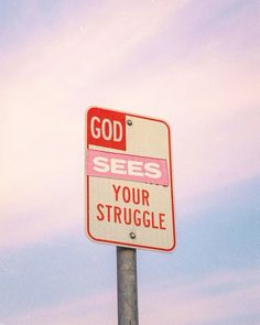 a red and white street sign that says god sees your struggle on the side of a pole