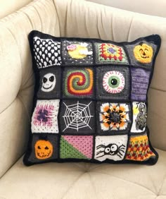 a crocheted pillow is sitting on a chair with a white cushion and black background