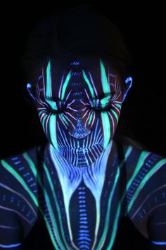 a woman's face is lit up with neon lights