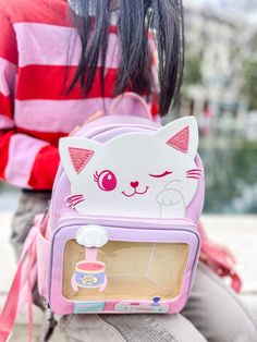 This friendly kitty backpack is the perfect pick-up for any pin-collecting feline fan! With a fun and colorful animal theme, this claw machine-inspired bag will keep you organized and purr-fectly stylish. Move over plain backpacks, this one is claw-some! Add your pin collection on the front zippered pocket & display them safely behind the clear window Pin board included for ease of switching out pins Small "claw" actually swivels left and right Glitter and embroidered details everywhere Open pockets on both sides Adjustable padded straps Kitty Backpack, Claw Machine, Colorful Animals, Packing Material, Animal Theme, Pin Collection, Zipper Pocket, Feline, Backpacks