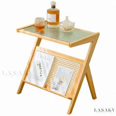 a wooden table with a magazine rack and bottles on it