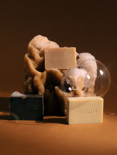 soaps, soap bars and soap cubes on a brown surface with the word vanilla written in it