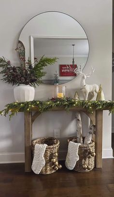 a christmas mantle with stockings on it and decorations in front of the mirror, along with other holiday items